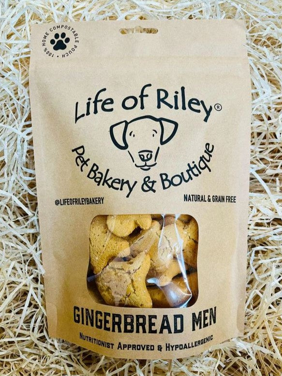 Bag of 'Gingerbread People' dog treats from Life of Riley Pet Bakery & Boutique on a straw background.