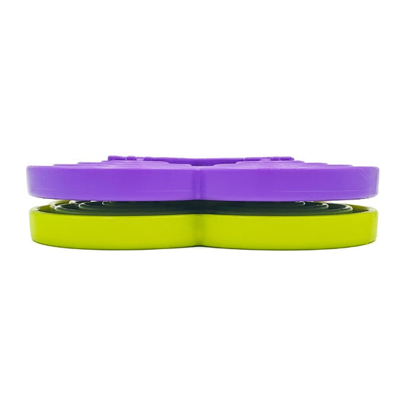 Purple and green slow feeders for dogs stacked on top of each other
